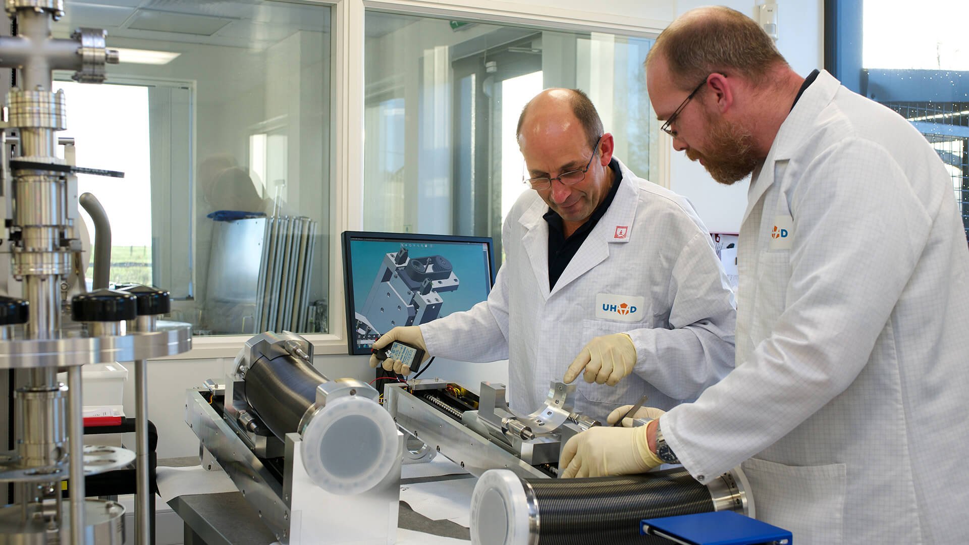 Engineers working on a UHV device